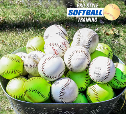 pro-style-softball-training--close-up-of-practice-softballs-in-metal-bucket