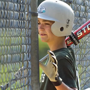 youth-girls-softball-player-holding-a-bat-waiting-for-her-turn-at-bat-300x300