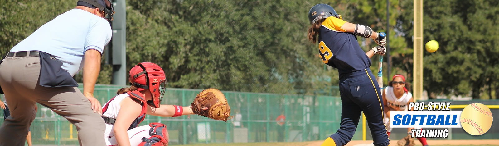 dugout-view-of-softball-batter-about-to-make-contact-with-the-ball.- Umpire-and-catcher-observing