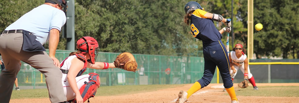 youth-softball-player-in-batters-box-making-contact-with-ball